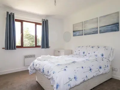 a bedroom with a bed with blue flowers on it at Chyrosen in Redruth