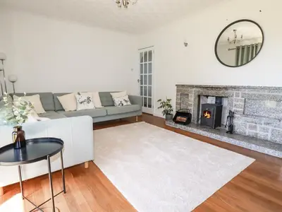 a living room with a couch and a fireplace at Chyrosen in Redruth
