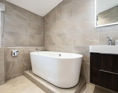 a bathroom with a white tub and a sink at Artemis in Saint Minver