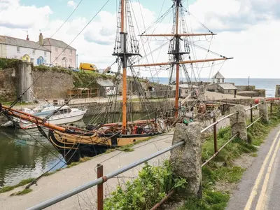 a ship docked in a harbor next to the water at Sebright in St Austell