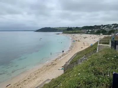 a beach with people swimming in the water at The Old Pirates Lookout in Falmouth