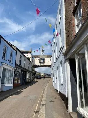 an empty street with flags and a bridge in the background at The Old Captains Lookout in Falmouth