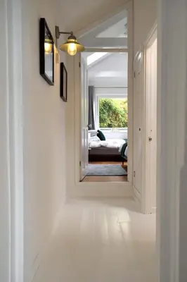 a hallway with a door leading to a bedroom at Cockleshell Cottage in Falmouth