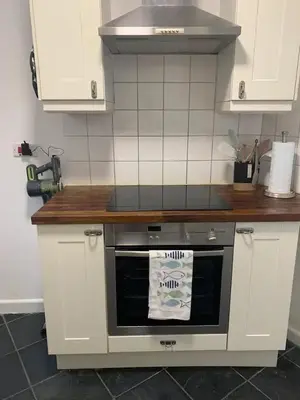 a kitchen with a stove and a counter top at Cockleshell Cottage in Falmouth
