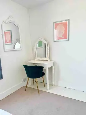 a room with a desk and a chair and a mirror at Cockleshell Cottage in Falmouth