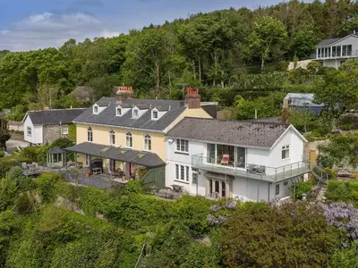 an aerial view of a large white house at Creekside House in Fowey