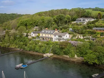 an aerial view of a house and a river at Creekside House in Fowey