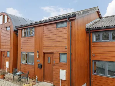a row of wooden houses with a patio at Maple in Falmouth