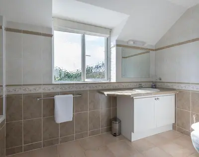 a bathroom with a sink and a window at Polmorla in Polzeath
