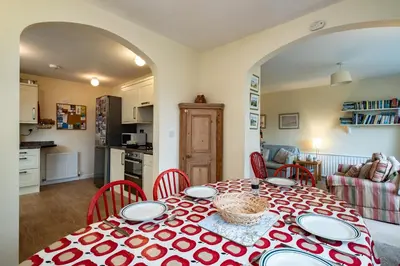 a kitchen and dining room with a table and chairs at Pencreek in Padstow