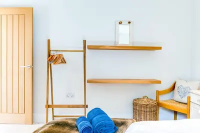 a bedroom with blue towels on a bed at Greystones Studio in Polzeath