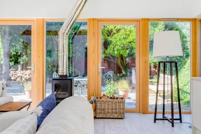 a living room with a couch and a fireplace at Greystones Studio in Polzeath
