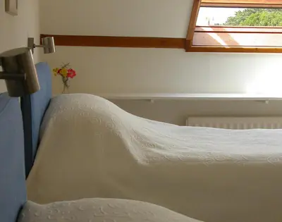 a bed in a room with a window at Rosevallen in Polzeath