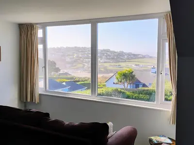 a large window in a living room with a couch at Chy-An-Var in Polzeath
