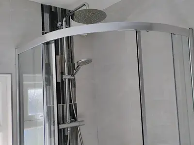 a shower with a glass door in a bathroom at Chy-An-Var in Polzeath