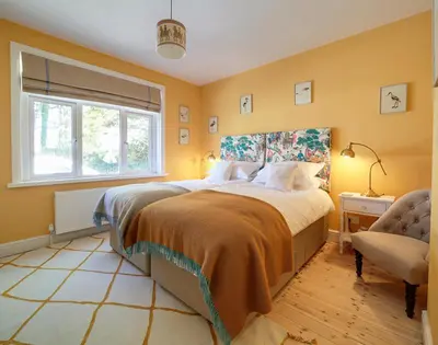 a bedroom with a large bed and a window at Trevanion in Saint Minver