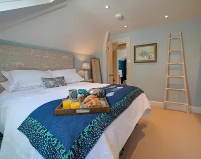 a tray of food on a bed in a bedroom at Trevanion in Saint Minver