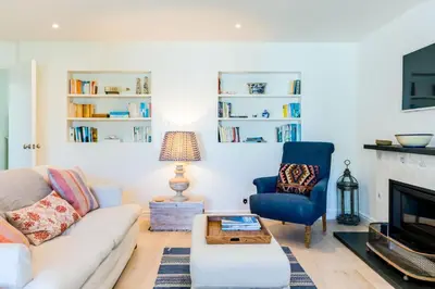 a living room with a couch and a chair at Greystones in Polzeath