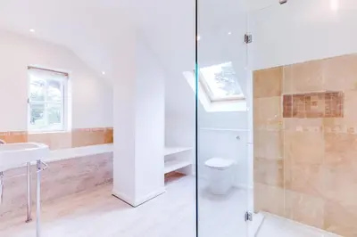 a bathroom with a shower and a toilet and a sink at Greystones in Polzeath