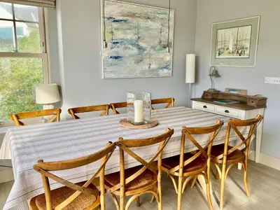 a dining room with a table and chairs at Westray House in Polzeath