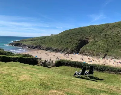 two chairs sitting on a hill next to a beach at Egloskerry in Wadebridge