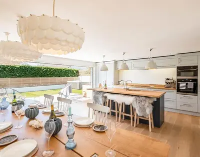 a kitchen with a table with wine glasses on it at Seastar in Wadebridge