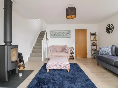 a living room with a couch and a fireplace at Gwel Nans in St. Agnes