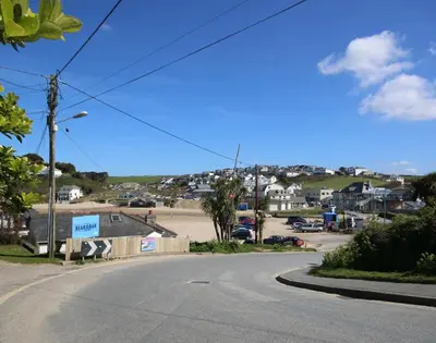 an empty street in a small town with houses at Coppingers Cottage in Polzeath