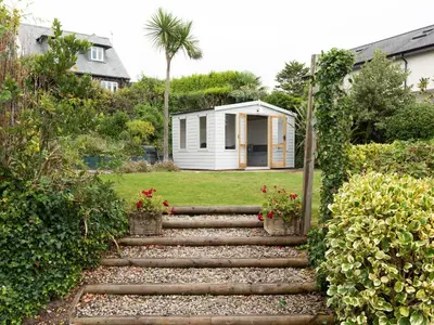a garden with stairs leading to a house at Little Strand in Padstow