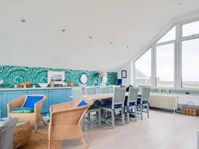 a dining room with a table and chairs at The Point in Polzeath