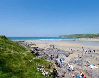 a group of people standing on a beach at The Granary in Saint Minver