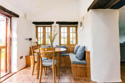 a dining room with a table and chairs at Dingles Cottage in Saint Minver