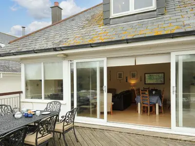 an extension to a house with sliding glass doors at Pendaveli in Polzeath