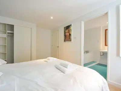 a white bed with two towels on top of it at The Old Granary in Saint Minver