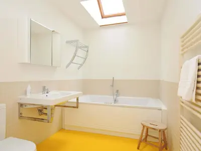 a bathroom with a sink and a bath tub at The Old Granary in Saint Minver