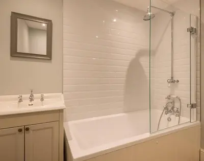 a bathroom with a shower and a tub and a sink at Carn Du 1 in Padstow