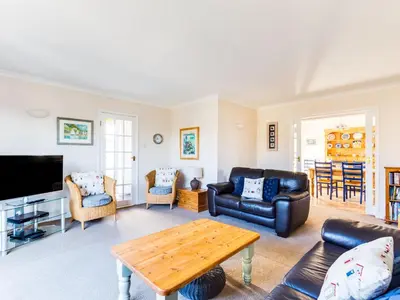 a living room with a couch and a table at Little Sailing in Padstow