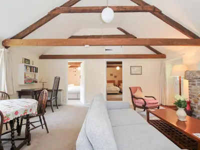 a living room with a couch and a table at Mill Pond in Saint Minver