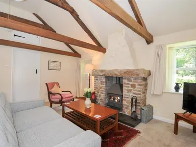 a living room with a couch and a fireplace at Mill Pond in Saint Minver