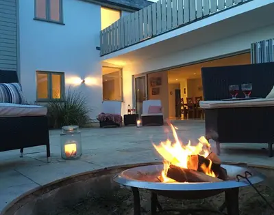 a fire pit in the middle of a patio at Downalong in Polzeath