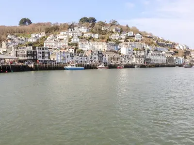 a group of houses on a hill next to the water at Smugglers Loft in Looe