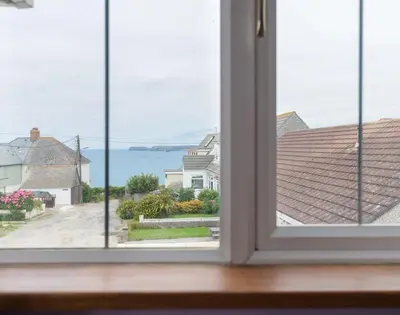 an open window with a view of the ocean at Fairholme in Port Isaac