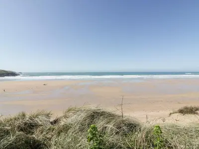 an empty beach with the ocean in the background at Fistral Apres Surf in Newquay