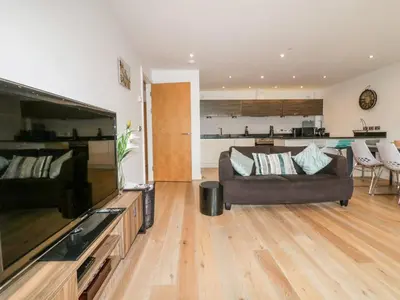 a living room with a couch and a large flat screen tv at Fistral Apres Surf in Newquay