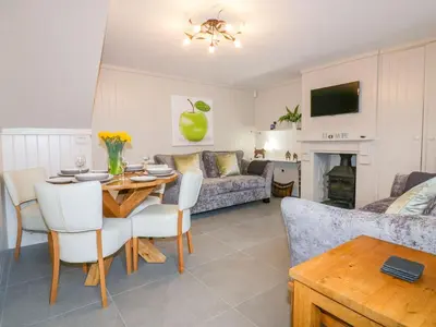a living room with a table and a couch at Apple Barn in Newquay