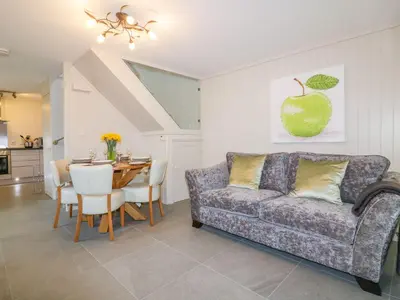 a living room with a couch and a table at Apple Barn in Newquay