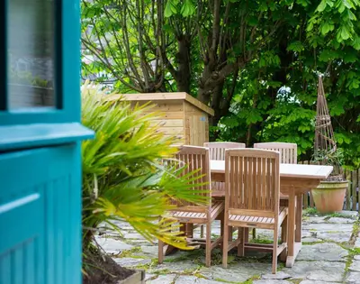 a wooden table and chairs sitting around a table and sidx sidx sidx at Crow's Nest in Port Isaac