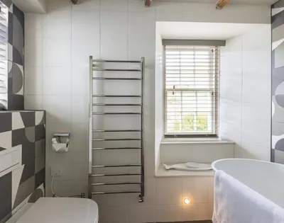 a bathroom with a tub and a toilet and a sink at Crow's Nest in Port Isaac