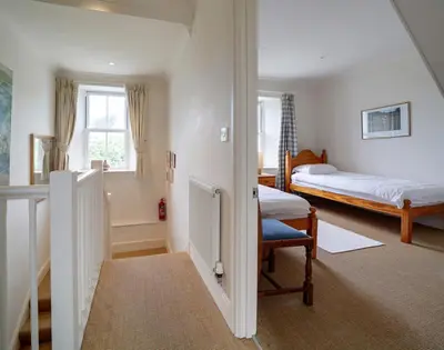 a room with a bedroom with a bed and a window at Worthy House in Polzeath