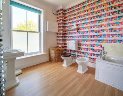 a bathroom with a toilet and a sink and a window at The Haven in Polzeath